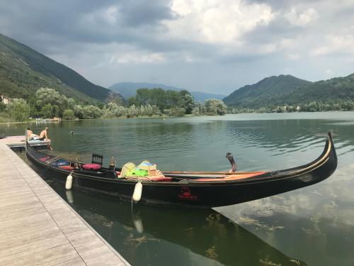 a boat is docked at a dock on a lake at CASA San Gallo in Farra di Soligo