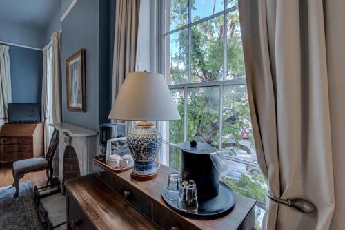 a lamp on a table in front of a window at Malaga Inn in Mobile