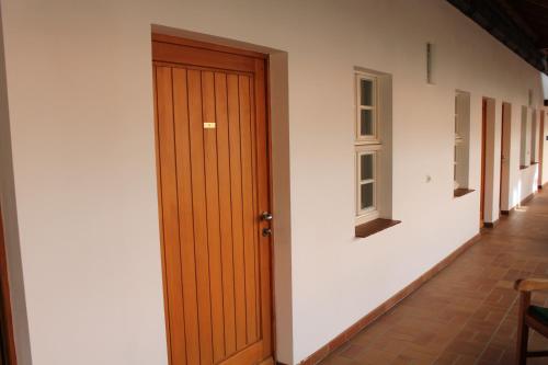 a wooden door in a room with a hallway at Hotel zum Brauhaus in Quedlinburg