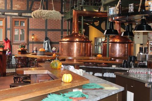 a large kitchen with copper pots and a counter at Hotel zum Brauhaus in Quedlinburg