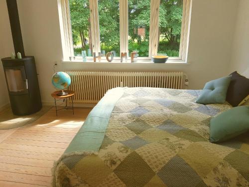 a bedroom with a bed in front of a window at Koege Guesthouse in Køge