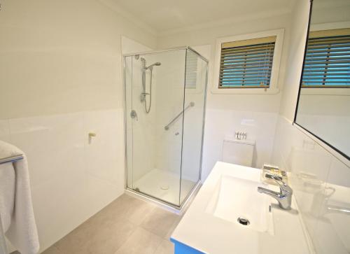 a white bath tub sitting next to a white toilet at Port Arthur Villas in Port Arthur