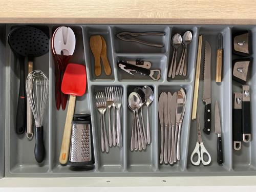 a tray filled with utensils in a drawer at Lyon Urban Cocoon Gîte urbain eco-responsable in Lyon
