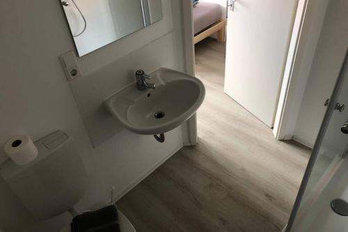 a bathroom with a sink and a mirror at Zimmer 3 in Alzenau in Unterfranken