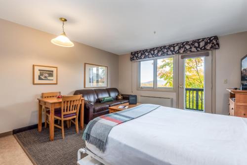 a bedroom with a bed and a table and a chair at Jordan Hotel in Newry