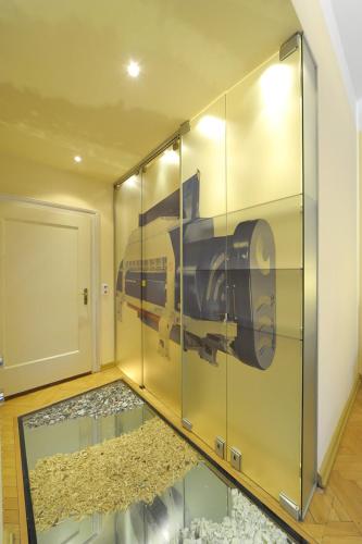 a glass elevator with a picture of a train on it at Erlebnis Post - Stadthotel mit EigenART in Spittal an der Drau