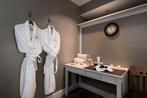 a room with white robes hanging on a wall at Jordan Hotel in Newry