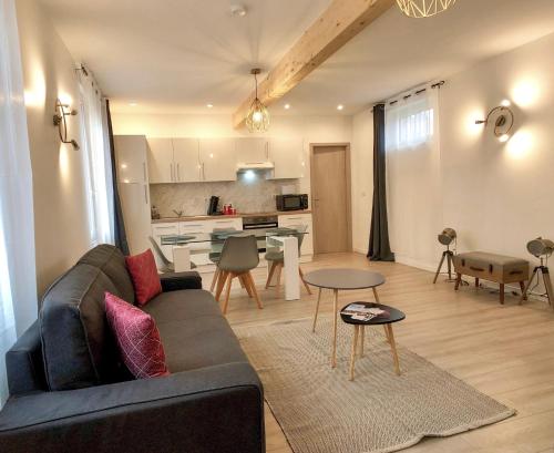 a living room with a couch and a table at Charming Home - City Center Cosy Apartments in Colmar