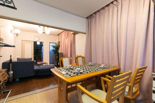a living room with a table and chairs at Shinjuku Japanese-style two storey house in Tokyo