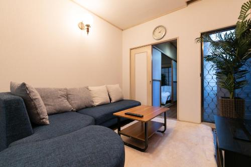 a living room with a couch and a table at Shinjuku Japanese-style two storey house in Tokyo