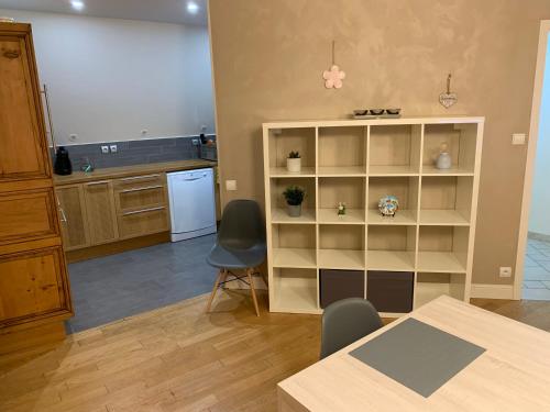 une cuisine avec une table, des chaises et une étagère à livres dans l'établissement Historical town center spacious flat, à Colmar