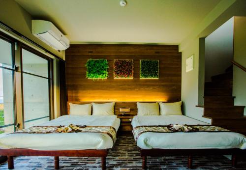 a room with two beds and a staircase in it at -Musée Villa- in Nakijin