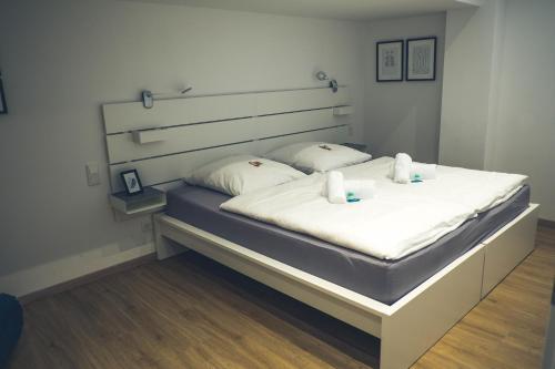 a bedroom with a large bed with white sheets at Stylisch eingerichtete Wohnung mitten in München! in Munich