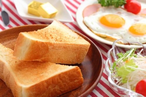 a plate of toast with eggs and a bowl of salad at Hotel Hoshitate Iriomotejima in Iriomote