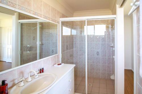 a bathroom with a sink and a shower at South Coast Retreat in Greenwell Point