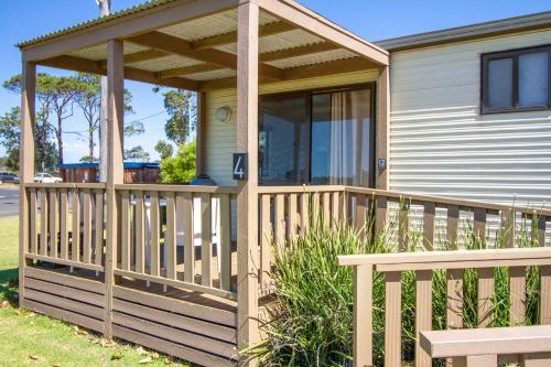 a porch on a house with a wooden deck at South Coast Retreat in Greenwell Point