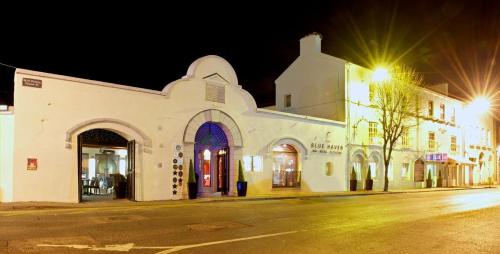 a white building on a city street at night at The Blue Haven Hotel in Kinsale