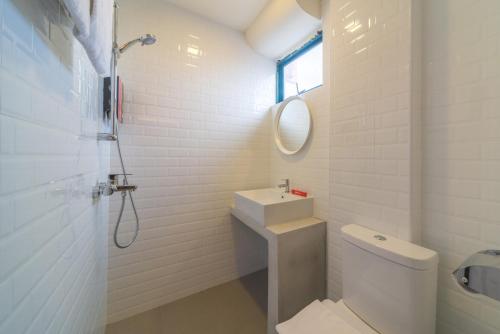 a bathroom with a toilet and a sink and a shower at RedDoorz at Geylang in Singapore