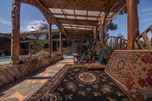 a pavilion with a couch and a rug on a patio at Casa Antigua Hotel in Alajuela City