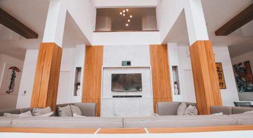 a living room with couches and a tv at Happy Family Villa in Phuket Town
