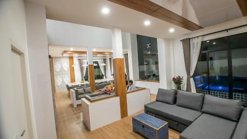 a living room with a couch and a table at Happy Family Villa in Phuket Town