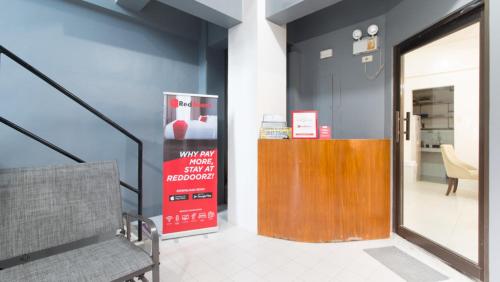 a hallway with a door and a bench in a building at RedDoorz near Liceo De Cagayan University Highschool in Cagayan de Oro