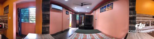 a hallway with pink walls and a rug on the floor at 12 Homestay Apartments in Siliguri