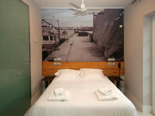 a hotel room with a bed and a window at Hosteria Santander in Santander