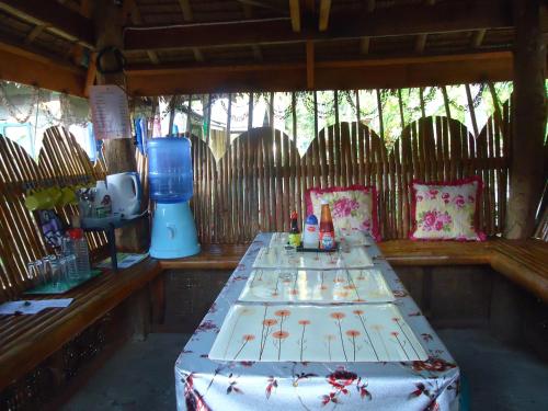 a room with a table with drinks on it at LHOYJEAN Garden Hostel in Batuan