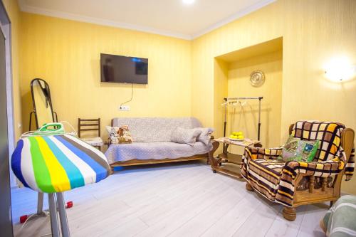 a baby room with a hospital bed and chairs at Guest House Happy Holidays in Tbilisi City
