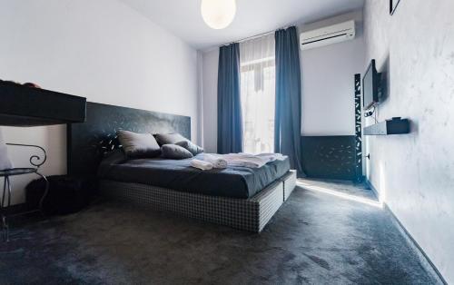 a bedroom with a bed and a large window at Vila 6aTo Hotel & Wellnes in Sofia