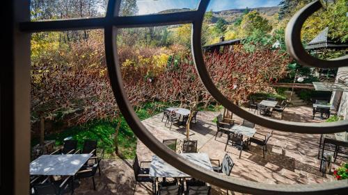 a view from a window of a patio with tables and chairs at Vila 6aTo Hotel & Wellnes in Sofia