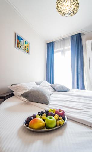 a plate of fruit sitting on top of a bed at Vila 6aTo Hotel & Wellnes in Sofia