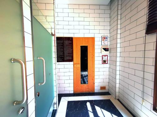 a bathroom with a brown door and a tile floor at D14 Venetian Condo Resort Pattaya Pool Connected Netflix in Jomtien Beach