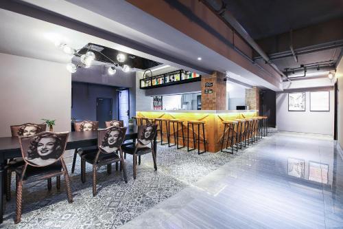 a dining room with a table and some chairs at Zou Qu Ye Travel Hotel in Chongqing