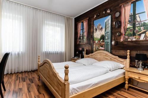 a bedroom with a bed and a wooden wall at Privathotel Stickdorn in Bad Oeynhausen