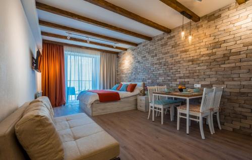 a bedroom with a bed and a table in a room at New Gudauri Atrium 335 in Gudauri