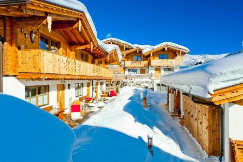 a snowy street in a ski resort with snow covered buildings at Alpendorf Anno Dazumal in Tux