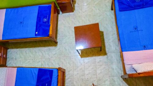 an overhead view of a bathroom with blue cabinets and a mirror at Miryams Village Inn Safari Lodge in Sultan Hamud