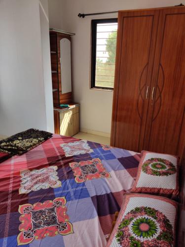 a bedroom with a bed and a dresser and a window at 2BHK AC Row House Bunglow in good locality in Nashik