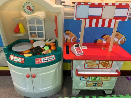 a toy kitchen with a table and a refrigerator at Howard Beach Resort Kenting in Kenting
