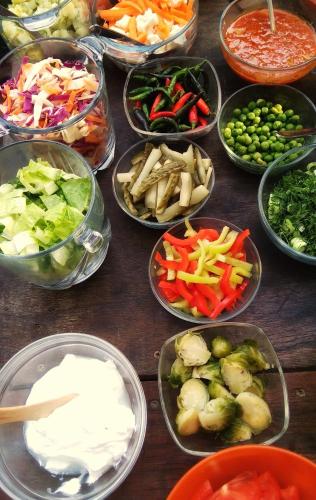 a table topped with bowls of different types of vegetables at Poco Loco Bed & Breakfast in Chania Town