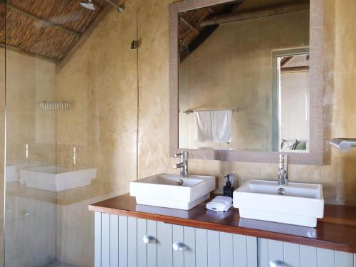 a bathroom with two sinks and a mirror at Salt Water House in Paternoster