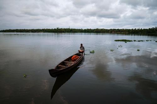 a person in a boat on a lake at Vismaya by Moksha Stays in Turavūr