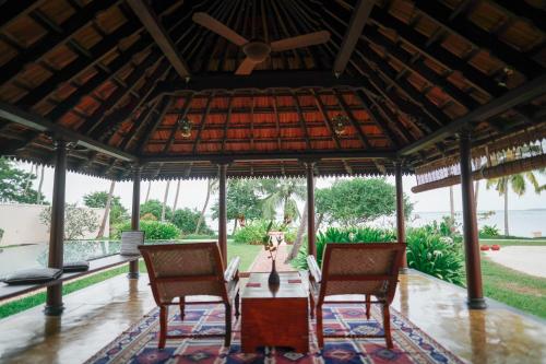 a dining room with a table and two chairs at Vismaya by Moksha Stays in Turavūr