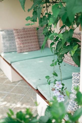 a bench in a room with a plant at Vismaya by Moksha Stays in Turavūr