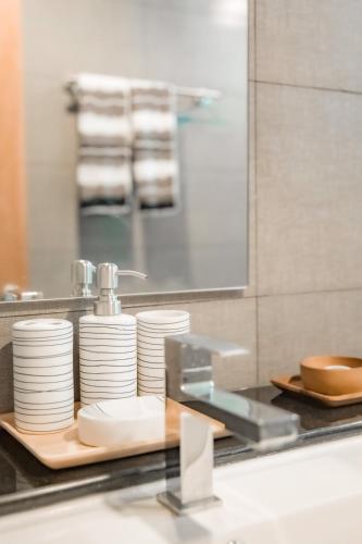 a pile of plates on a counter in a kitchen at THE BEACH CHA AM Suites in Cha Am