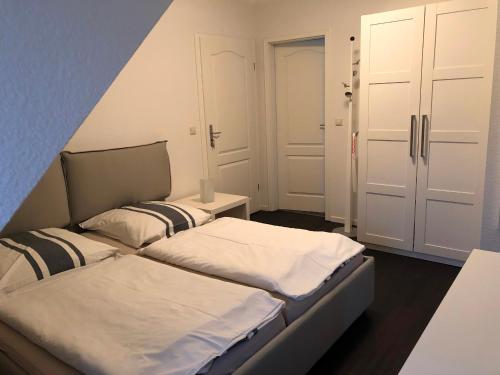 a small room with two beds and a closet at Urlaub in Wieck in Wieck