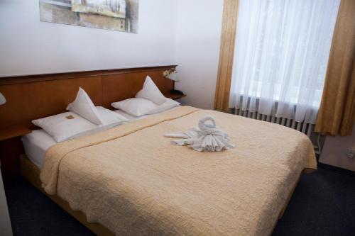 Postel nebo postele na pokoji v ubytování Hotel Baden