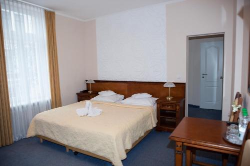 a hotel room with a bed with a towel on it at Hotel Baden in Bonn